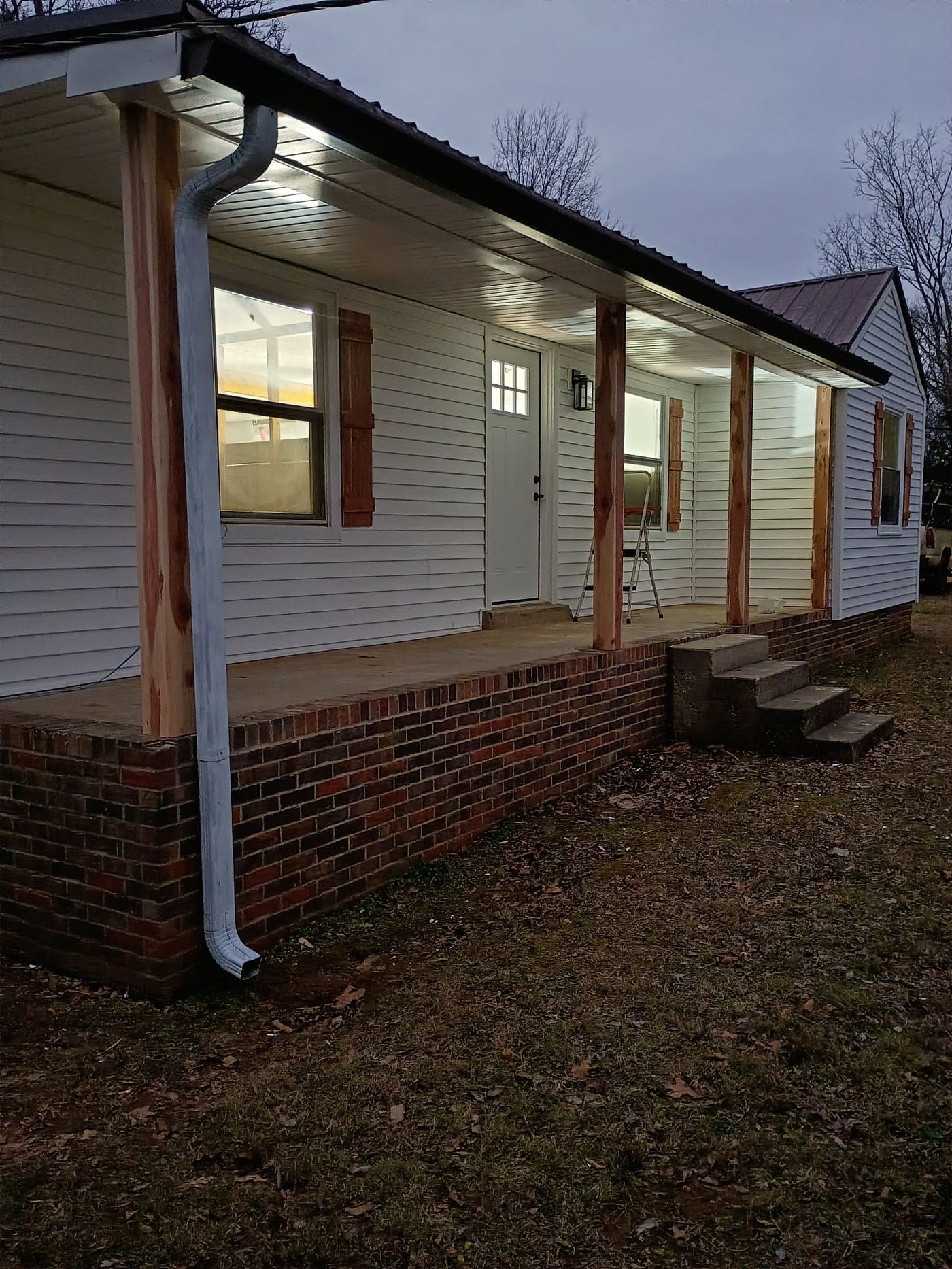 House after new vinyl siding, windows, shutters and gutters